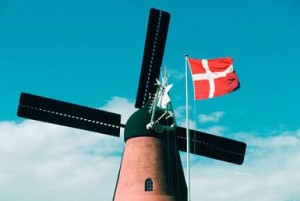 Low angle view of a windmill and the Danish flag, Funen County, Denmark